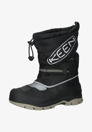 Botte d'hiver noire imperméable avec semelle beige, sangle ajustable, cordon de serrage en haut et grand logo "KEEN" sur le côté.