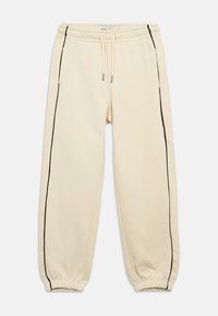 Beige sweatpants met zwarte zijstrepen, elastische tailleband en boorden. Voorzien van een trekkoord en zijzakken voor functionaliteit.