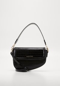Black crocodile-embossed leather handbag with a curved design, featuring a short top handle and a detachable shoulder strap. Gold hardware accents.