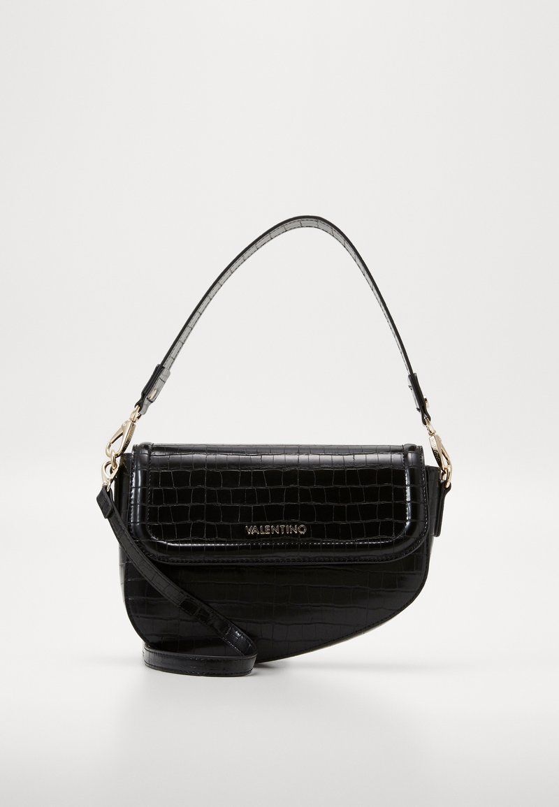 Black crocodile-embossed leather handbag with a curved design, featuring a short top handle and a detachable shoulder strap. Gold hardware accents.