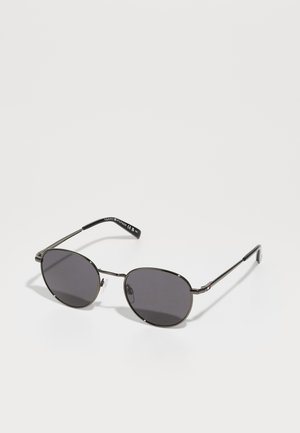 Metal sunglasses with oval dark gray lenses, thin black frames, and a subtle logo on the temple. Features adjustable nose pads.