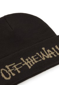 Sort strikket hue med en foldet kant, der har beige bogstaver, der læser "OFF THE WALL" i en fed, stiliseret skrifttype.