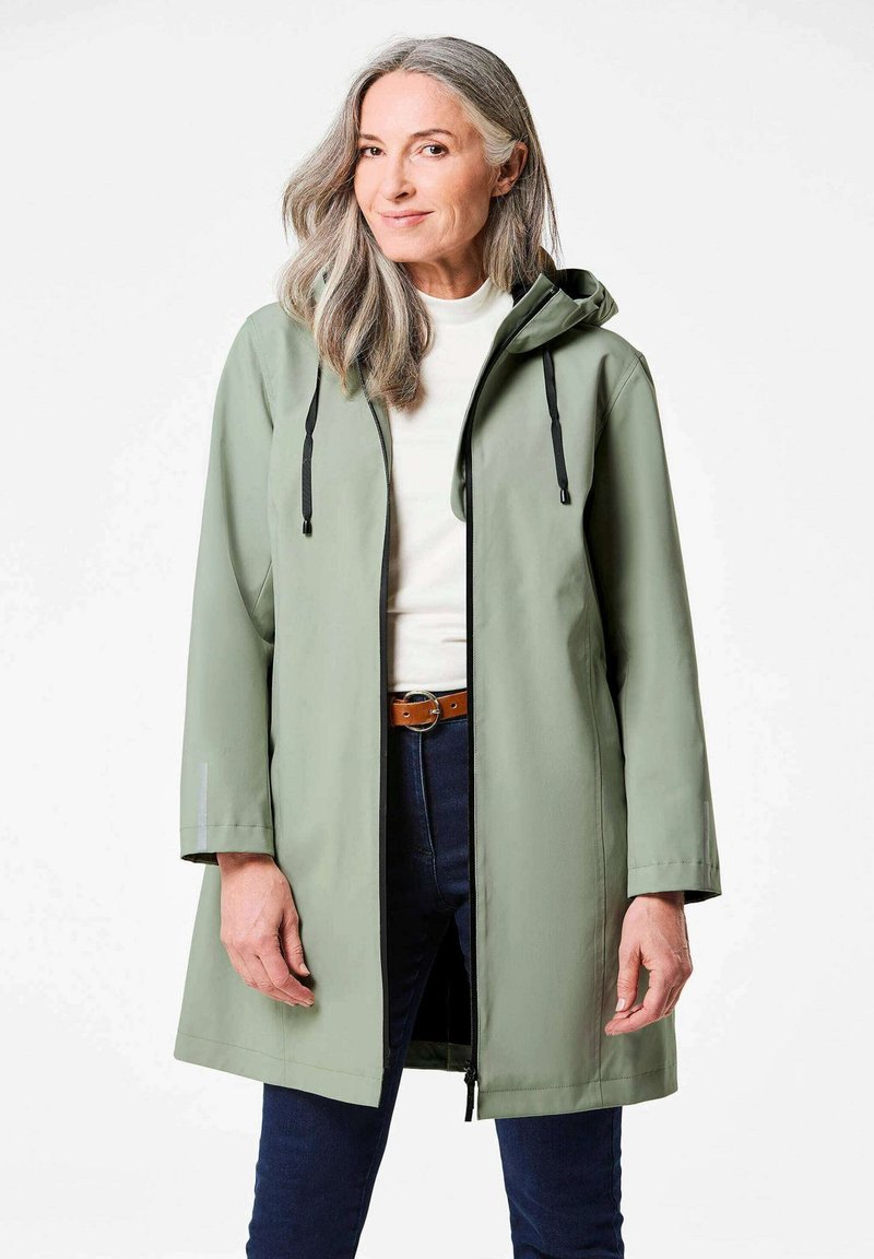 Lichtgroene waterdichte jas met capuchon, voorzijde met rits en verstelbare trekkoorden. Heeft een losse pasvorm en lange mouwen met reflecterende accenten.
