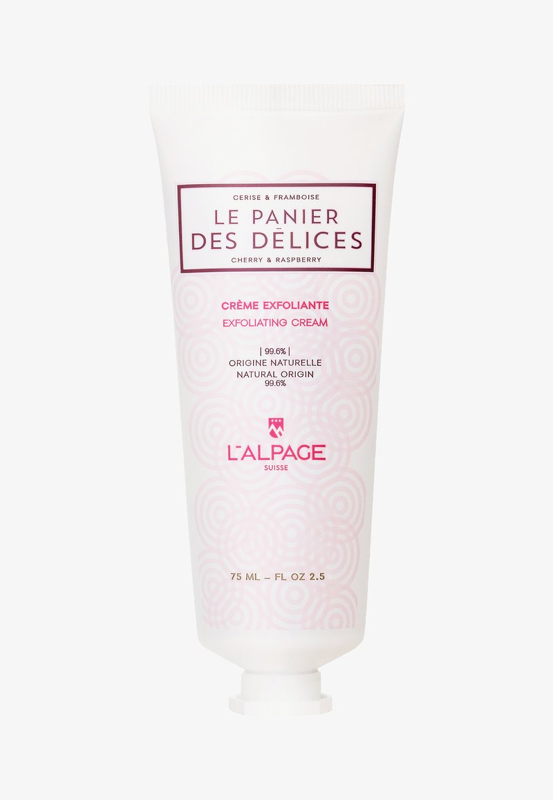Tube de crème exfoliante, 75 mL. Blanc avec des motifs circulaires roses. Comprend du texte rouge, la base du capuchon et des détails sur les ingrédients naturels.