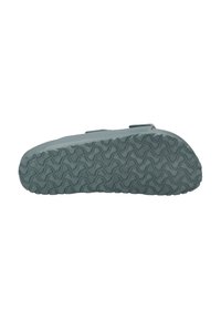 Gray rubber shoe sole with textured tread pattern, featuring a soft, smooth finish and rounded edges for improved grip and stability.