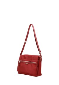 Red shoulder bag with adjustable strap, front zip pocket, and rectangular shape, made from textured material.