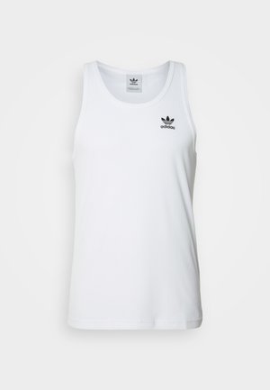 White ribbed tank top with round neckline, black Adidas logo on the left chest, and no sleeves. Soft cotton material, casual fit.