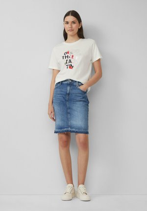 White cotton t-shirt with graphic text, paired with a knee-length blue denim skirt featuring frayed hem and classic five-pocket design.