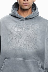 Grey sweatshirt with a hood, featuring textured embroidery of the word "Favela," decorative rays, and the year "2015." Kangaroo pocket included.