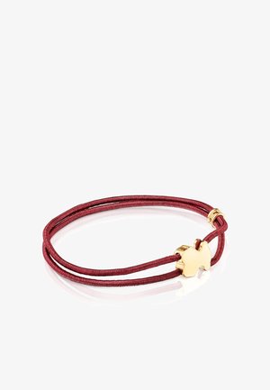 Red satin cord bracelet with gold metal clasp shaped like a butterfly. Dual strands tied together with smooth texture and polished finish.