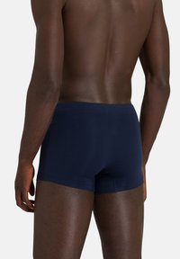 Marinblå boxershorts i stretchbomull, med en snug passform, slät Textur och minimalistisk design utan synlig branding.