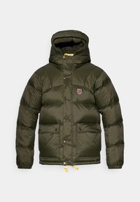 Veste d'hiver matelassée vert foncé avec capuche, dotée d'une fermeture éclair à l'avant, de deux poches avant et d'un patch de la marque sur la poitrine. Ourlet ajustable avec cordon.