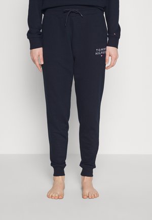 Marineblauwe trainingsbroek van zacht katoen, met een elastische tailleband met trekkoorden en een logo-detail op de dij. Met boordjes aan de enkels.