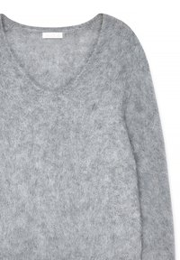 Grey sweater with a V-neck, featuring a soft, textured knit. The material appears lightweight and loosely woven, enhancing comfort.