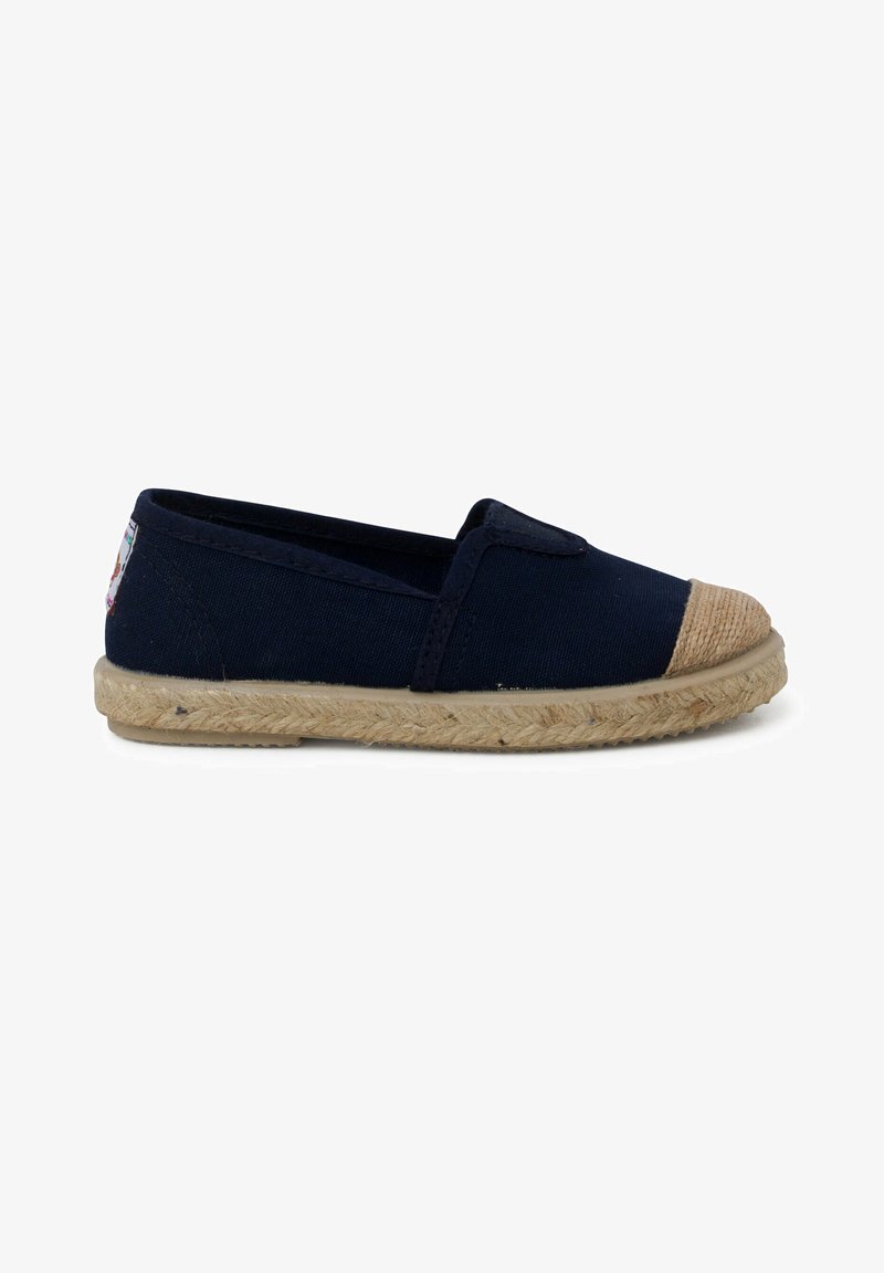 Chaussure bateau en toile navy à enfiler avec une semelle en corde de jute et un embout beige. Dispose d'inserts élastiques sur les côtés pour un enfilage facile.