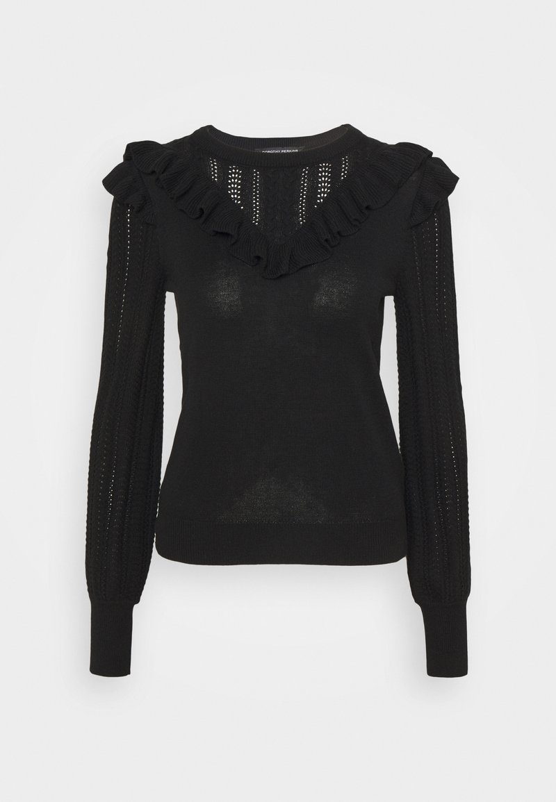 Pull en maille noir à manches longues avec encolure en V à volants et détails en maille ajourée à motifs sur les manches et le haut de la poitrine.