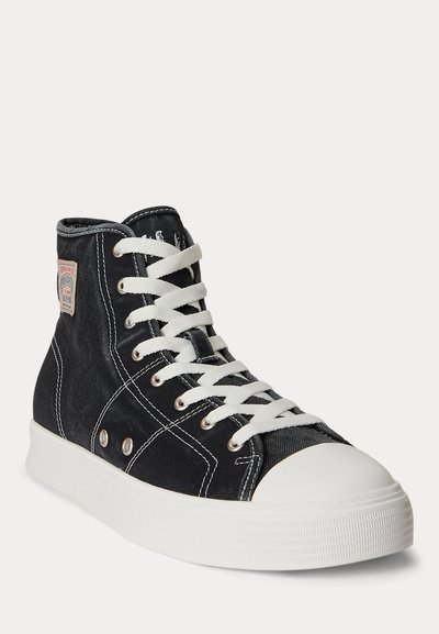 Black high-top canvas sneaker with white laces, white rubber sole, toe cap, and contrast stitching shown at a three-quarter angle.