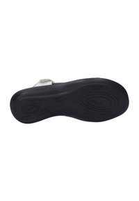 Black sole of a sandal featuring a textured grip, light gray upper with adjustable strap; soft padding visible near the toe area.