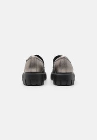 Metallic grey shoes with a textured leather upper, black rubber sole, and round toe. Features a cushioned collar and minimalist design.
