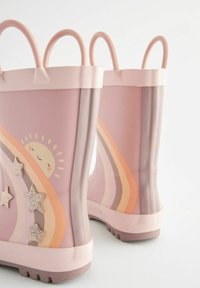 Bottes de pluie en caoutchouc rose avec un motif arc-en-ciel, un soleil souriant et des étoiles scintillantes. Poignées arrondies et semelles texturées pour une meilleure adhérence.
