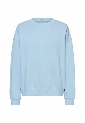 Jasnoniebieska bluza wykonana z miękkiego materiału, z okrągłym dekoltem, opuszczonymi ramionami oraz ściągaczami na mankietach i dole. Prosty design.