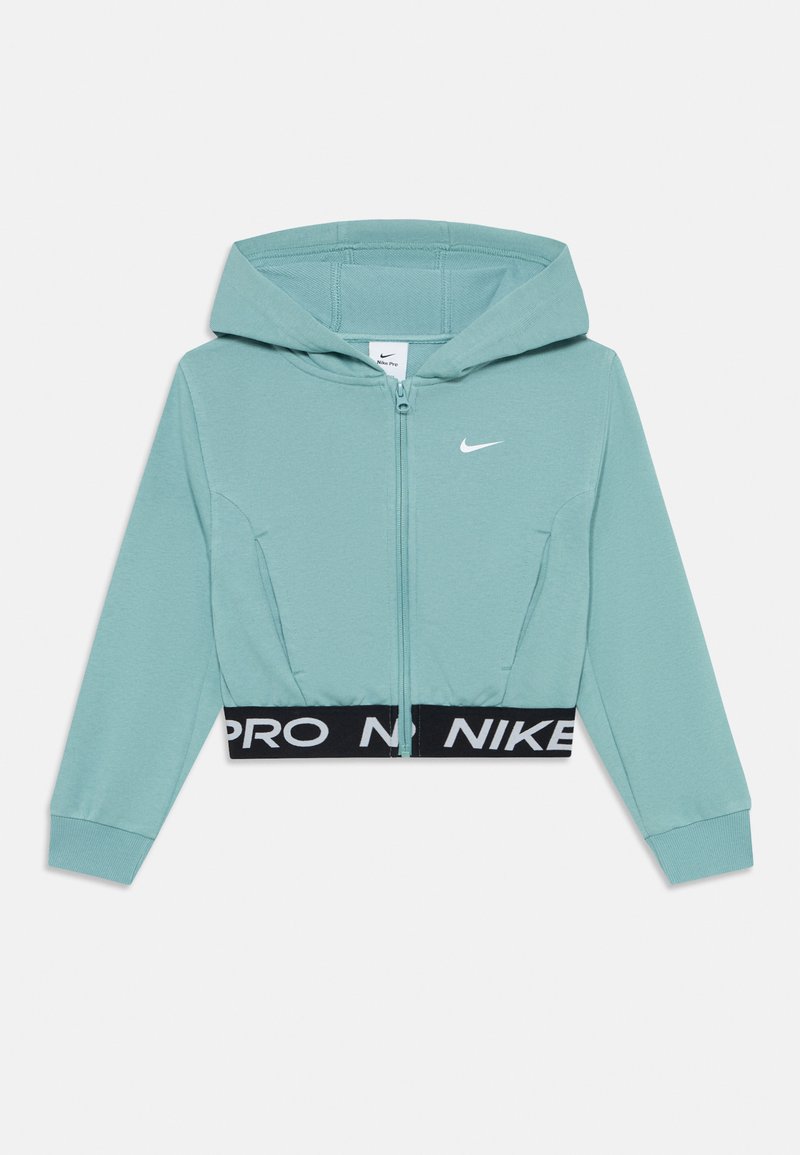 Haut à capuchon zippé bleu pâle avec capuche, manches longues, petit logo blanc Nike sur la poitrine, et taille élastique noire avec le texte "NIKE PRO".