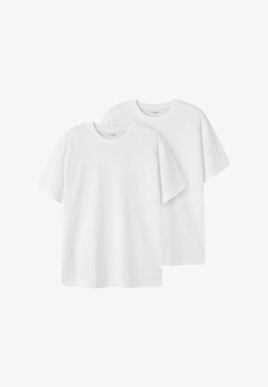 Dvije jednostavne bijele pamučne majice kratkih rukava, okruglih izreza i opuštenog kroja, blago preklopljene.