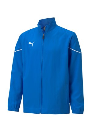 Blauwe trackjack gemaakt van gladde stof, met een rits aan de voorkant, hoge kraag en witte accenten. Logo weergegeven op de linkerborst.