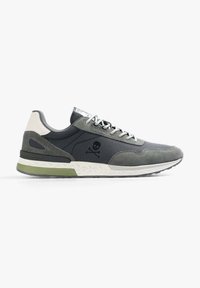 Sneaker sportive in grigio scuro e verde oliva, con una tomaia in suede e tessuto, suola testurizzata e logo di teschio sul lato.