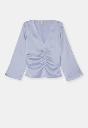 Light lavender top with a V-neck, long gathered sleeves, and ruched detail at the front. Made from textured fabric, cropped at the waist.