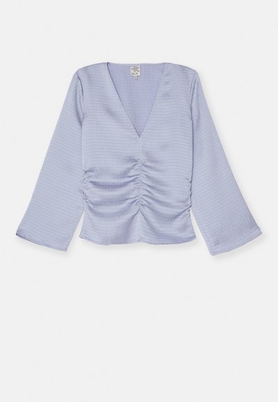 Lys lavendel topp med V-hals, lange samlet ermer og ruchingdetalj foran. Laget av strukturert stoff, avkortet i midjen.