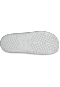Sole di scarpa in gomma bianca con un motivo di grip testurizzato, composto da forme a spina di pesce e rettangolari. I segni per la taglia e il marchio sono visibili.