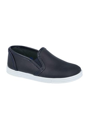 Zapato informal negro tipo slip-on con suela de goma blanca, paneles laterales elásticos y material superior liso, aislado sobre fondo blanco.