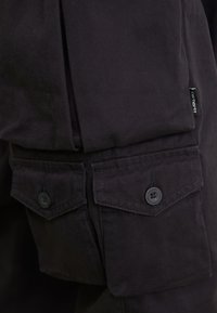 Carhartt WIP TRACKER PANT - Cargobukser - black