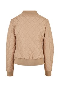 Blouson aviateur matelassé beige avec surpiqûres en losange, col, poignets et ceinture côtelés, vu de dos.