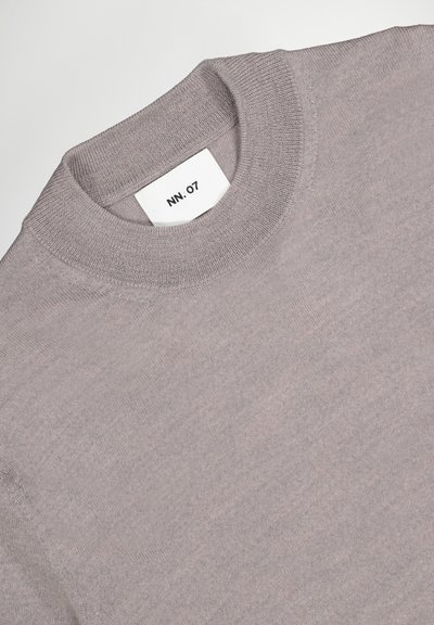 Light gray sweater made of soft knit fabric, featuring a round neckline and a label with "NN. 07" displayed prominently inside.