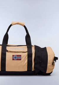 Beige and black duffel bag made of durable material, featuring a zippered main compartment, a Norwegian flag patch, and prominent logo detailing.