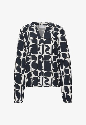 Blusa de manga larga en blanco y negro con patrón geométrico abstracto y cuello en V.