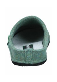 Green felt slipper with a rounded shape, textured surface, and a soft interior. Features a black outsole and a fabric label inside.