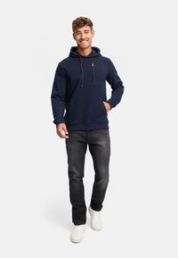 Navy blue hoodie made from soft fabric, featuring a kangaroo pocket, adjustable drawstring hood, and contrasting black and white drawcords.