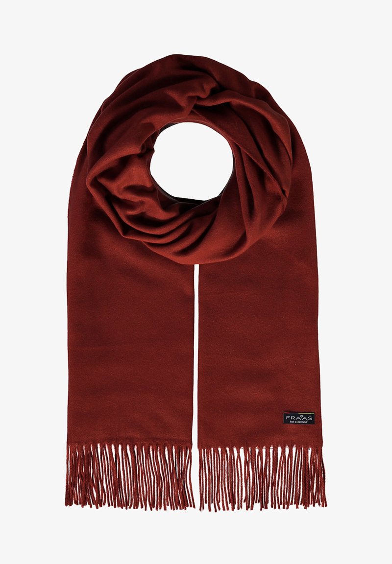 Sciarpa color ruggine realizzata in materiale morbido, con orlo frangiato e un piccolo logo di marca. Ripiegata in uno stile ad anello per maggiore calore.