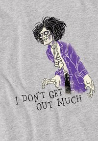 Gray t-shirt featuring a cartoonish zombie-like figure with messy black hair, purple clothing accents, and the text "I DON'T GET OUT MUCH" below.