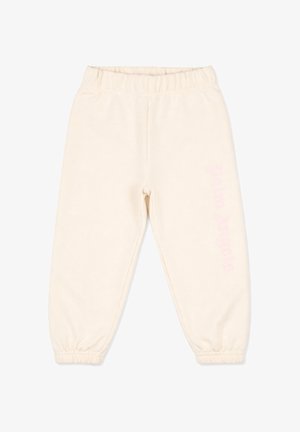 Pantaloni jogger in pile color crema con vita e polsini elastici, disposti in posizione distesa su sfondo bianco.