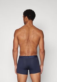 Dunkelblaue Boxer-Briefs mit einem breiten, dunkelblauen Levi's-Logo-Bund, gefertigt aus einem glatten, dehnbaren Stoff. Passform ist körpernah.