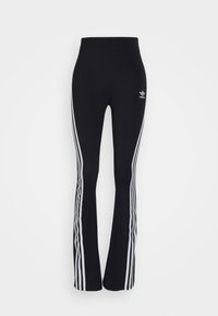 Svarta flare leggings med hög midja, prydda med vita sidostråk och en liten vit logotyp på övre vänstra låret. Slät yta.