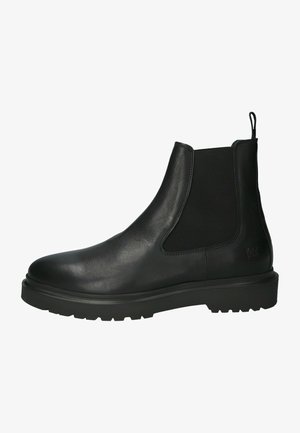 Bottines Chelsea en cuir noir avec des panneaux élastiques sur les côtés, bout rond et semelle en caoutchouc texturé. Équipées d'une boucle au talon pour un enfilage facile.