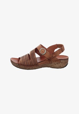 Brown leather sandal with perforated straps, a silver buckle, cork wedge sole, and an adjustable back strap.