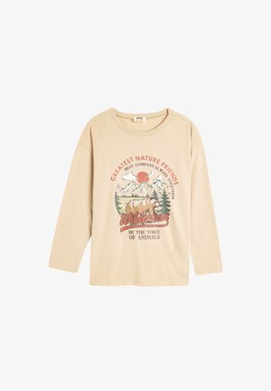 Beżowa, długorękawowa koszula z miękkiej bawełny z graficznym wzorem w stylu vintage, przedstawiającym góry, niedźwiedzia i tekst o naturze. Okrągły dekolt i luźny krój.