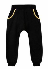 Schwarze Jogginghose mit elastischem Bund, zwei seitlichen Taschen mit gelben Akzenten, schmal zulaufenden Beinen und gerippten Bündchen. Aus weichem Stoff gefertigt.