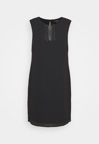 Robe noire sans manches avec un col rond, présentant des rangées verticales de clous en argent sur le devant et une silhouette droite.